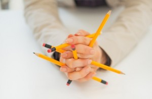 Closeup on business woman holding pencils